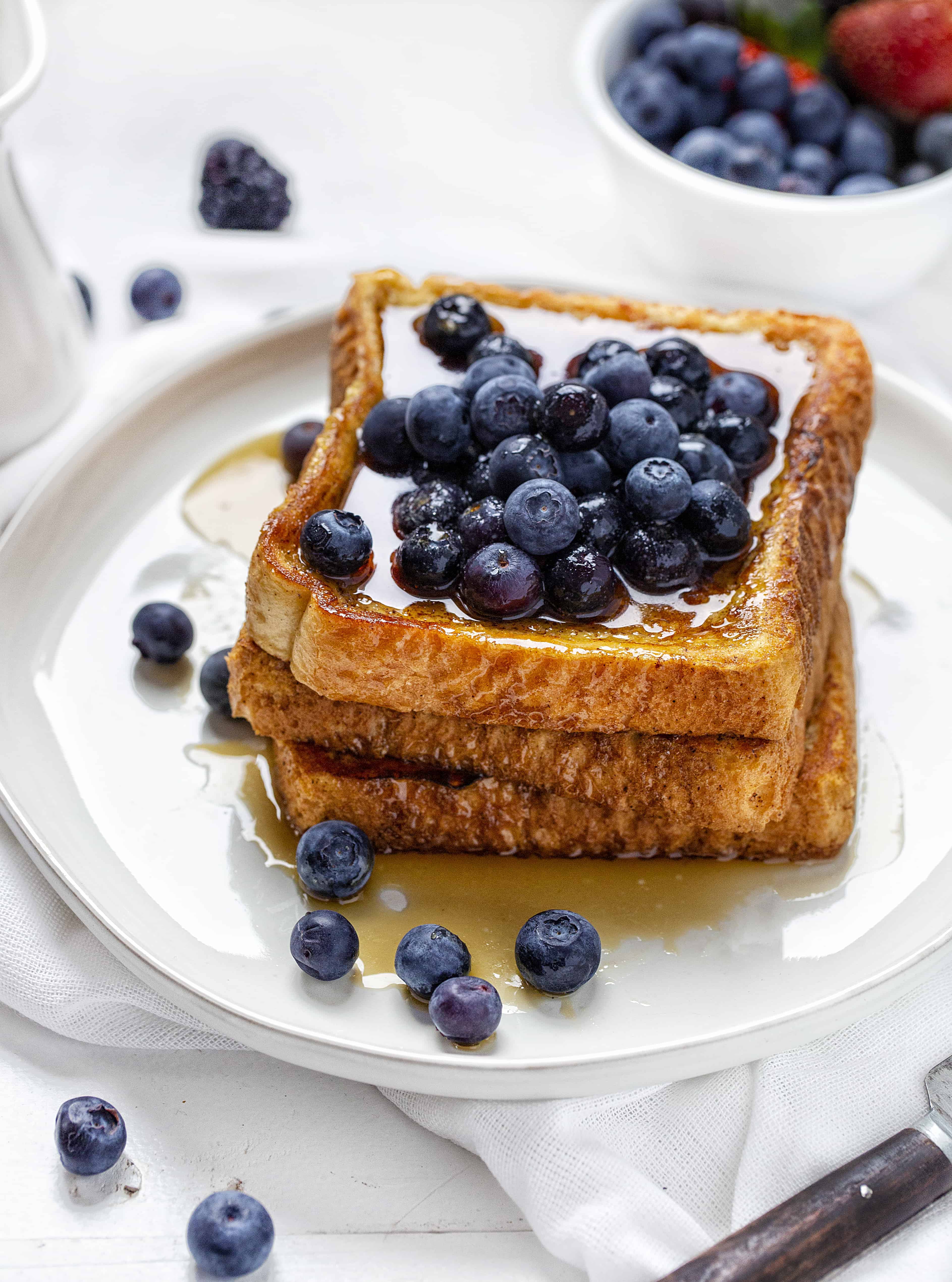 No-Fail French Toast Stacked and Covered in Blueberries. 