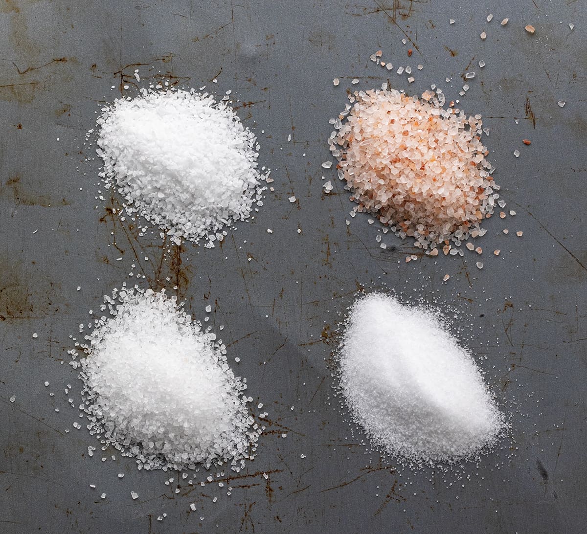 Showing Four Different Salts, Table Salt, Sea Salt, Kosher Salt, and Himalayan Salt.