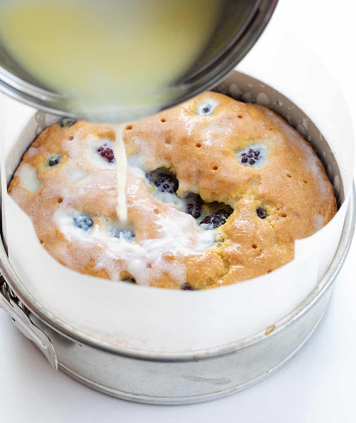 Pouring Milk Butter Mixture Over Blackberry Breakfast Cake.