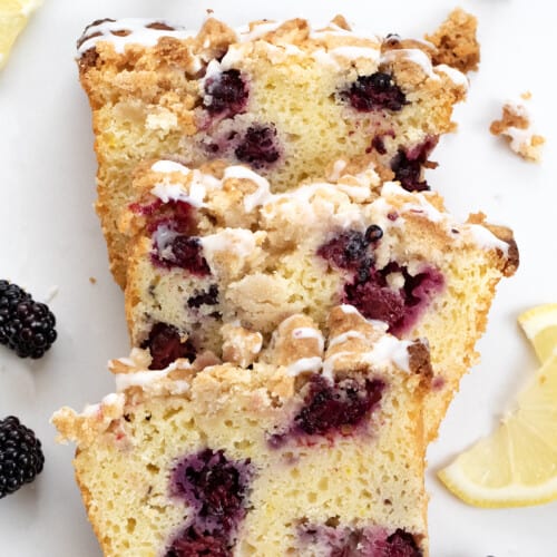 Pieces of Blackberry Lemon Loaf on a White Counter.