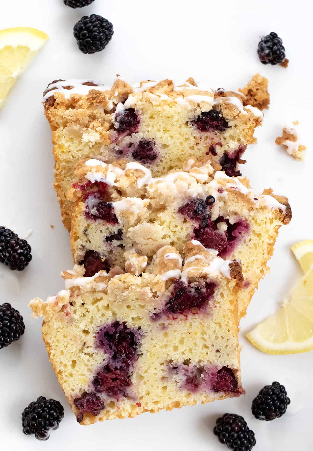 Pieces of Blackberry Lemon Loaf on a White Counter.