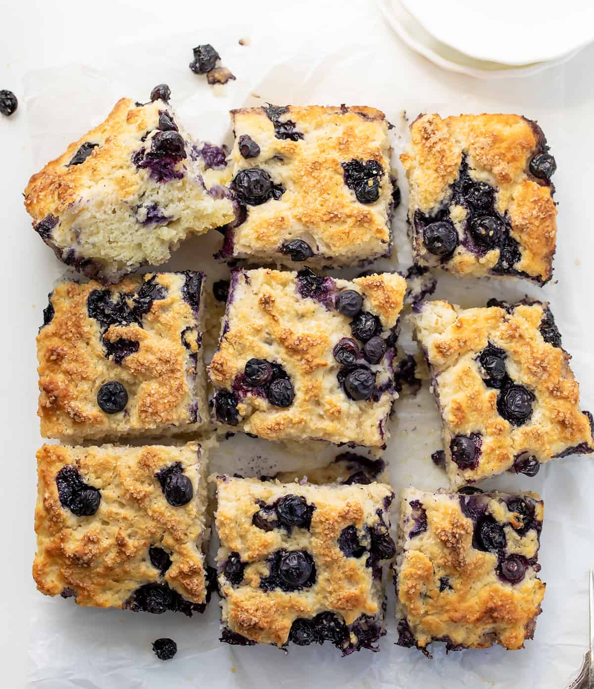 Blueberry Butter Swim Biscuits on a White Counter from Overhead and Cut Into Pieces.