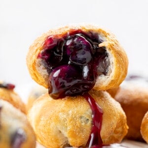 Stacked Blueberry Pie Bombs with One Cut in Half and Blueberry Pie Filling coming out. Breakfast, Blueberry Pie Bombs, Fruit Filled Hand Pies, Air Fryer Recipes, Blueberry Breakfast, Baked Blueberry Desserts, Dessert, Cherry Pie Bombs, Baked Pie Bombs, recipes, i am baker, iambaker
