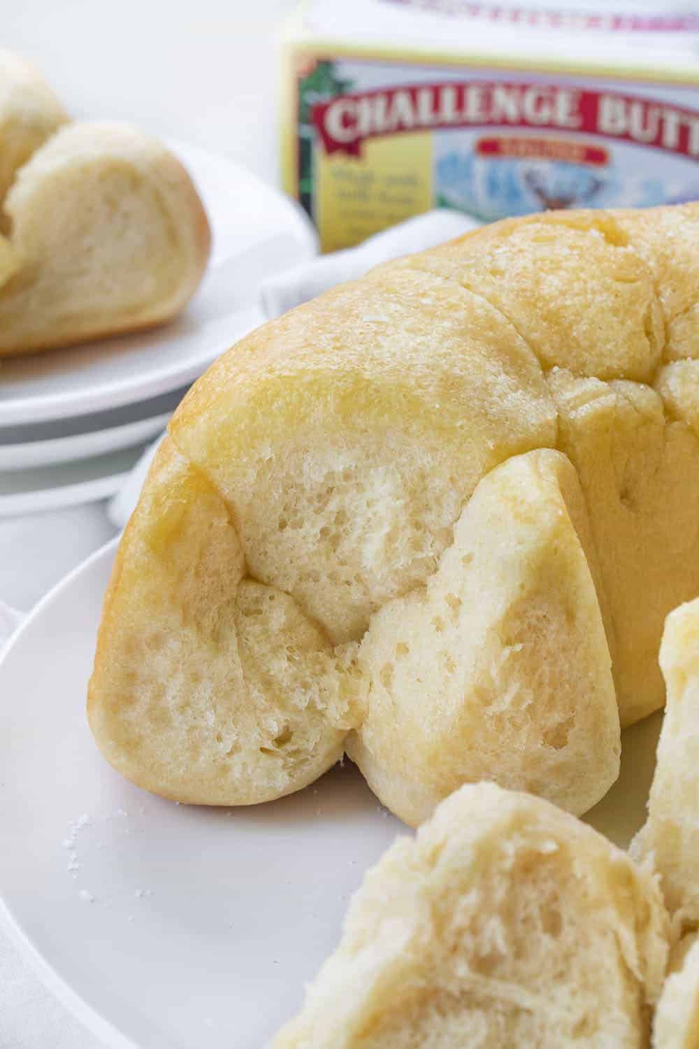 Bubble Bread Recipe with Pieces Removed Showing Inside and Pieces on a Plate Behind