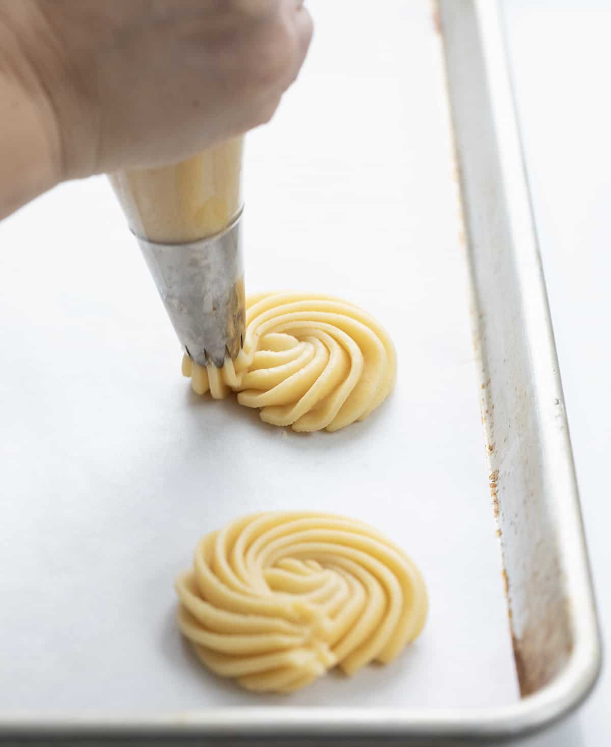 Piping a butter cookie.