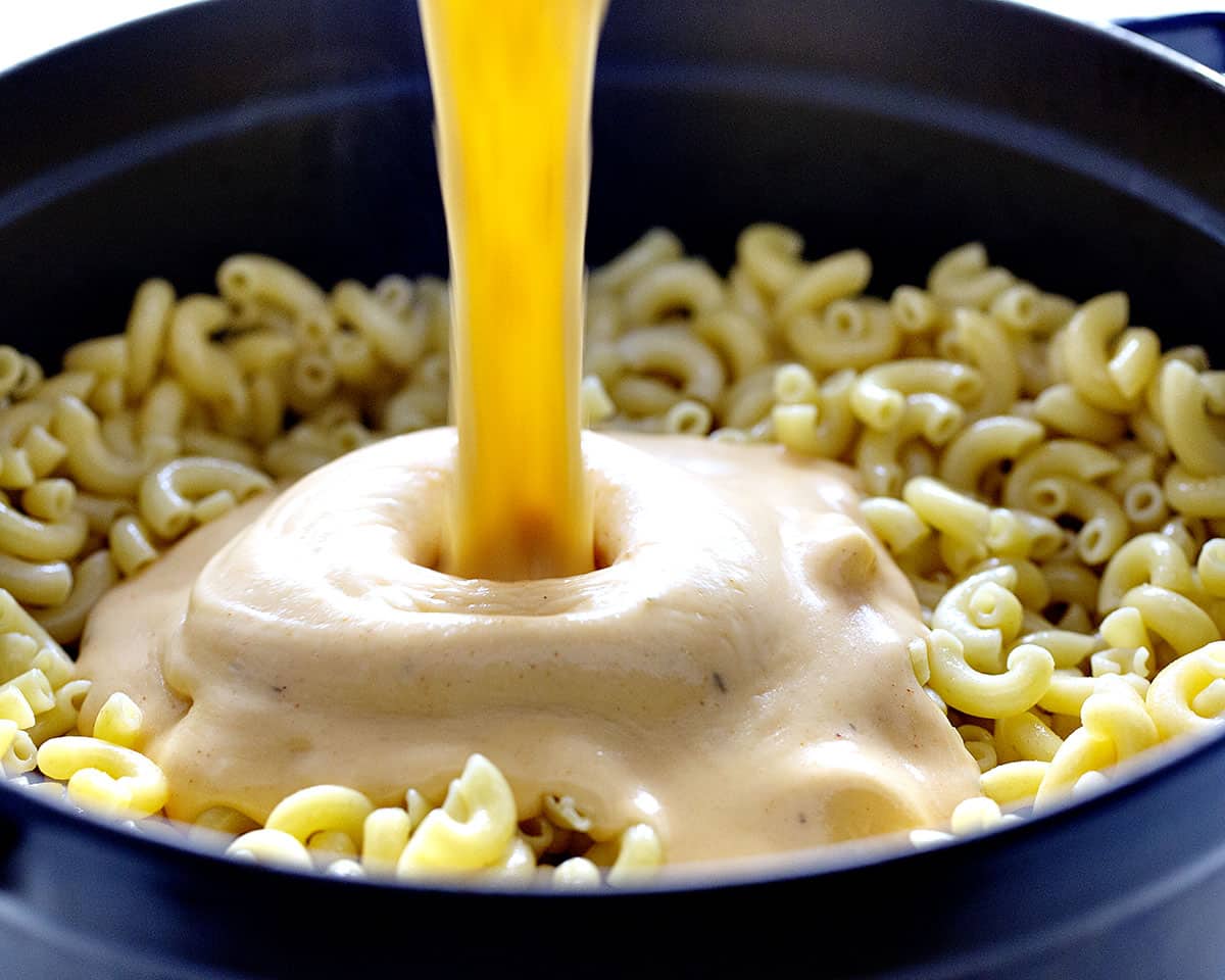 Pouring Cheese into Cajun Chicken Macaroni and Cheese