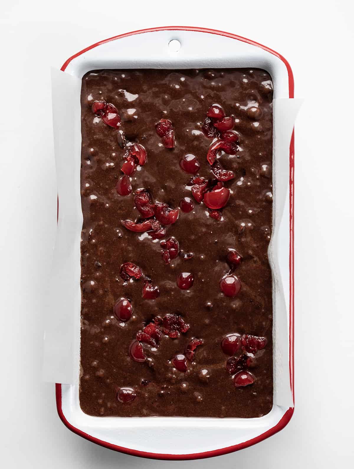 Raw Cherry Brownie Bread Batter in a Pan Showing Cherries.