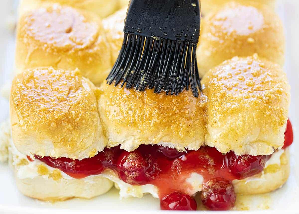 Spreading Topping Over Cherry Cheesecake Sliders