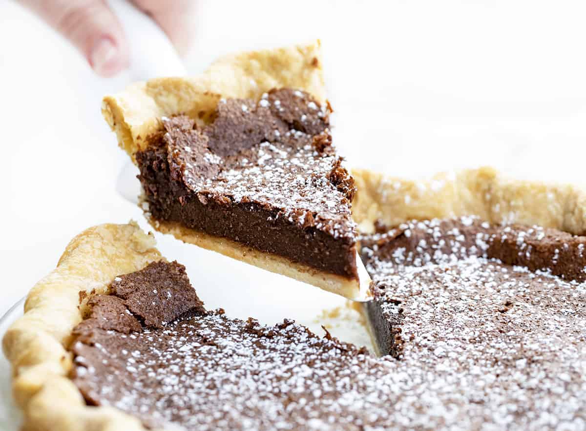 Removing a Piece of Chocolate Cheese Pie from Pie Plate