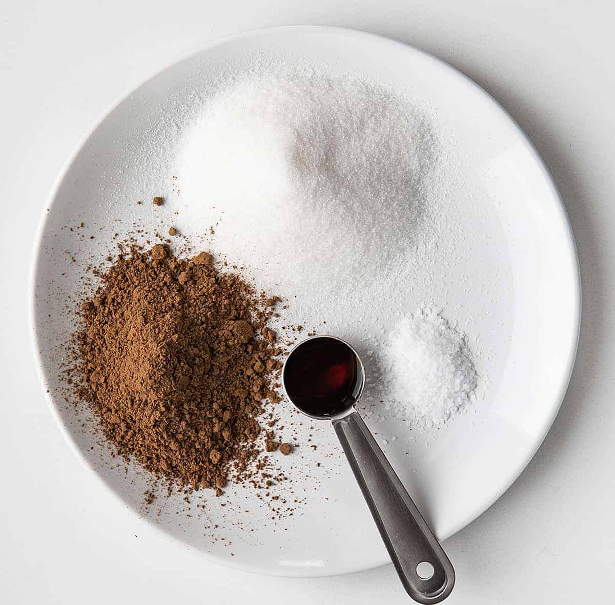 Raw Ingredients for Homemade Chocolate Fudge Sauce on White Plate