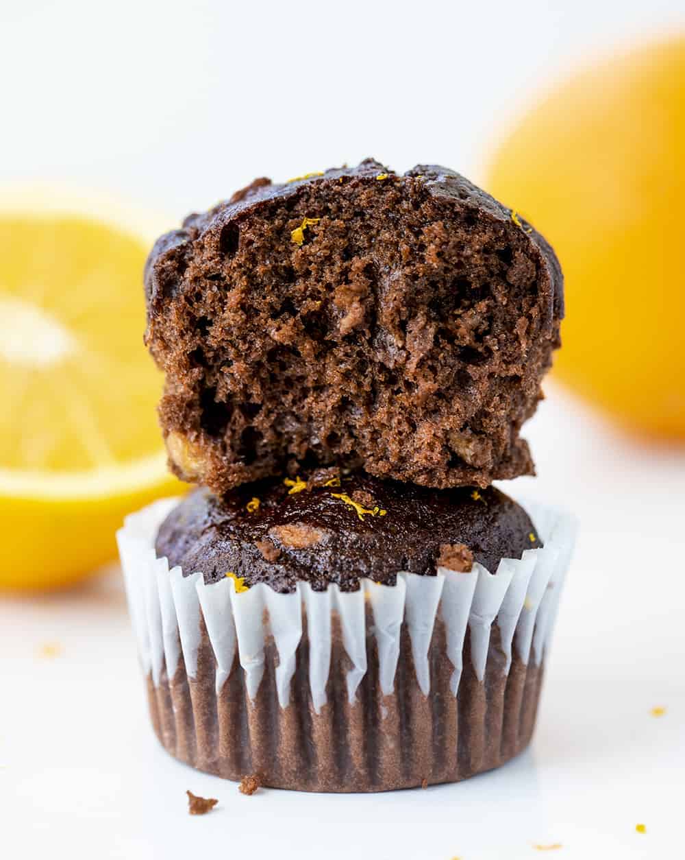 Stacked Chocolate Orange Muffins with One Cut in Half to Show the Inside