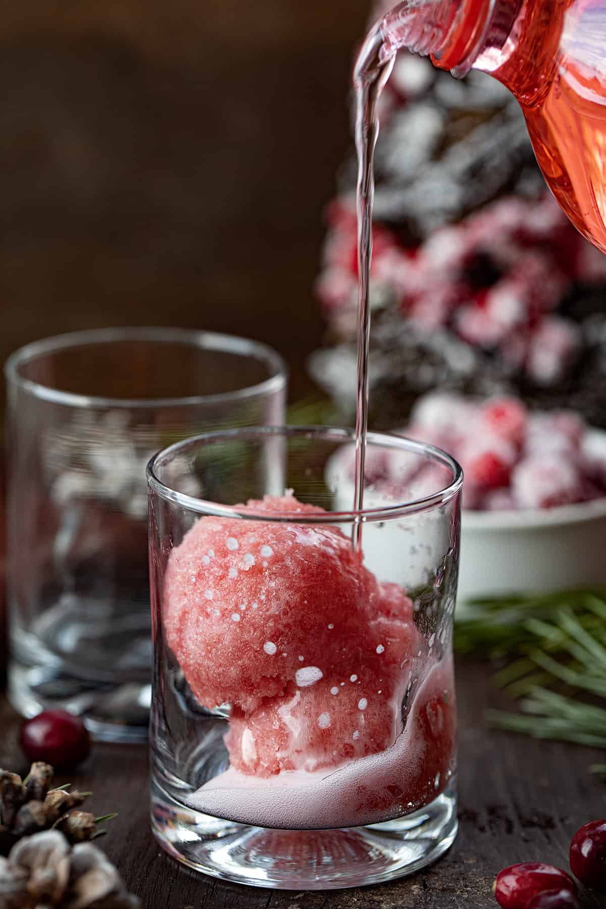 Pouring Cherry Soda into a Christmas Slush Mocktail.