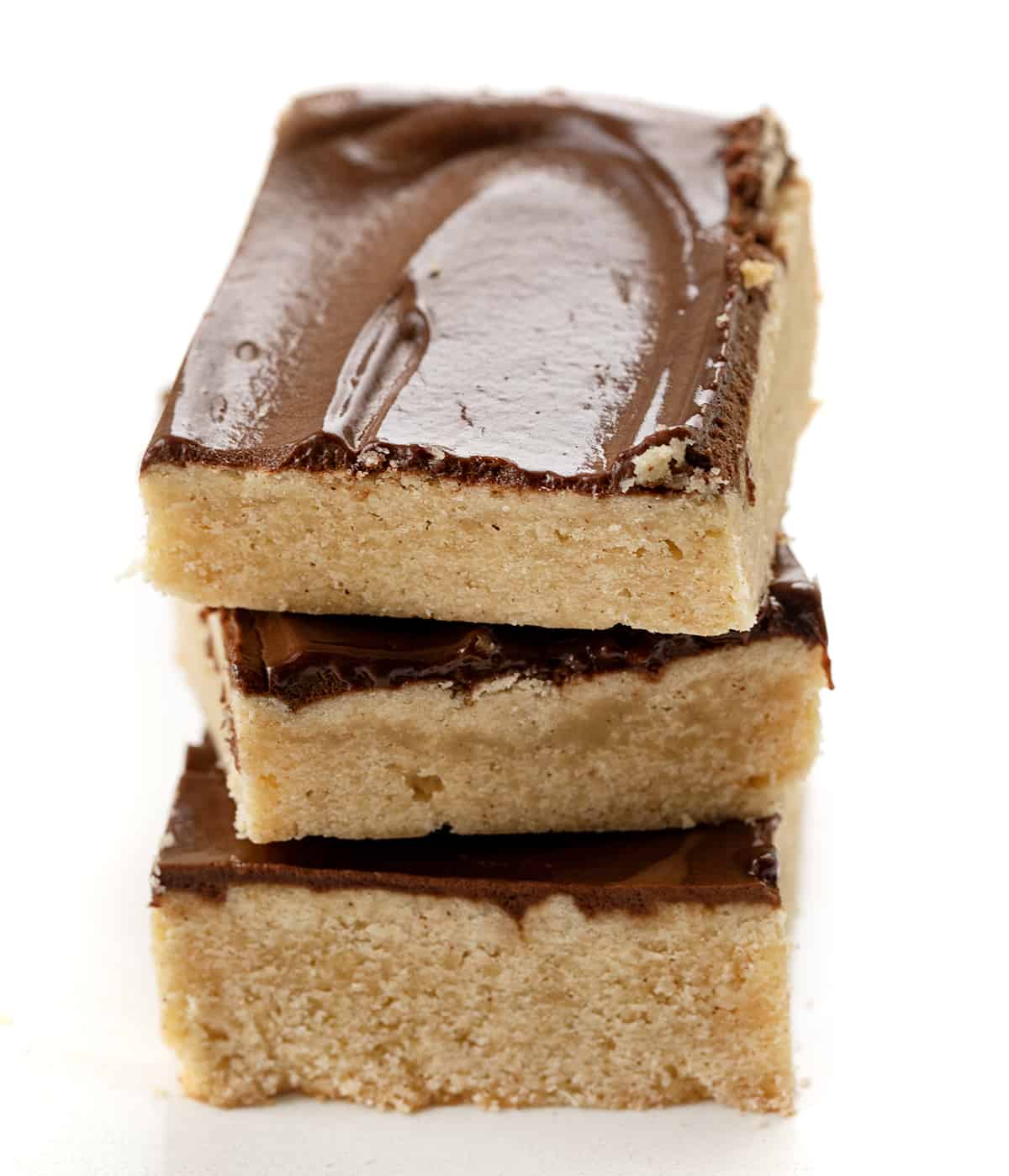 Cinnamon Shortbread Bars Stacked on a White Counter.