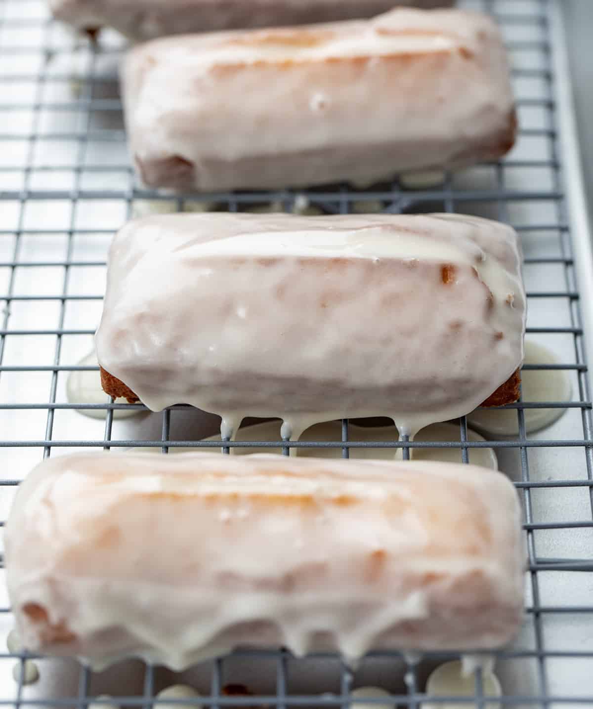 Donut Sticks on a rack after glaze has been applied.