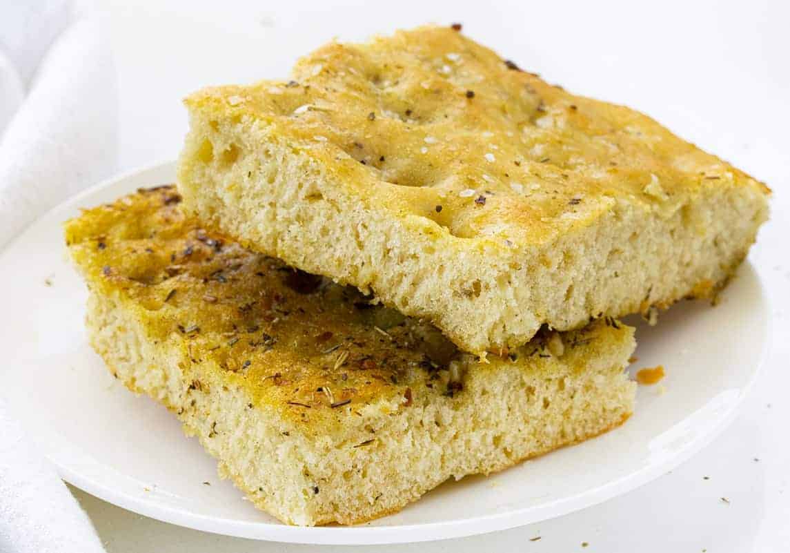Easy Focaccia Bread Cut into Slices and on a White Plate