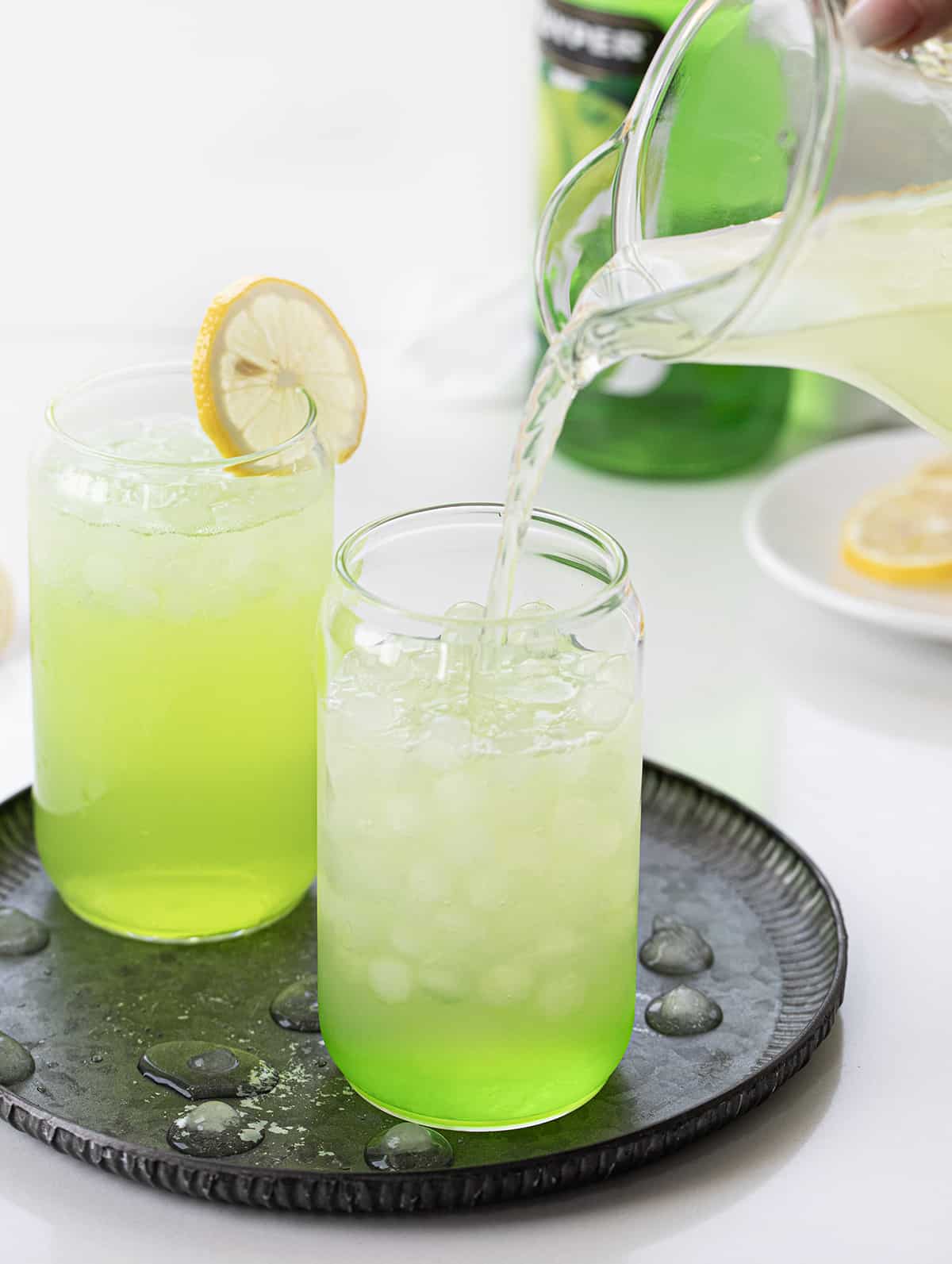 Adding Lemonade to Glass to Make Hulk Smash Cocktail.