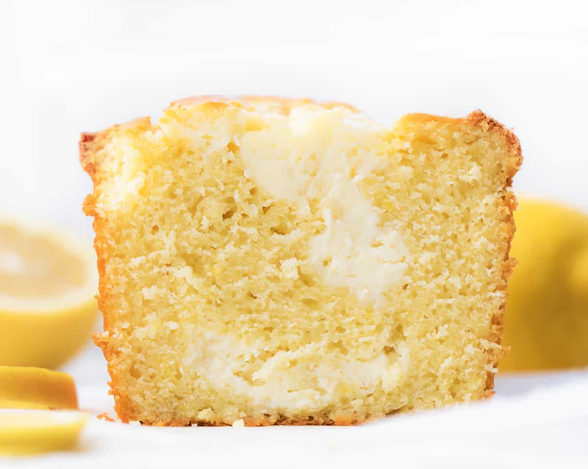 Sliced Lemon Cream Cheese Loaf with Lemons Around It.