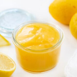 Jar of Lemon Curd next to lemons.