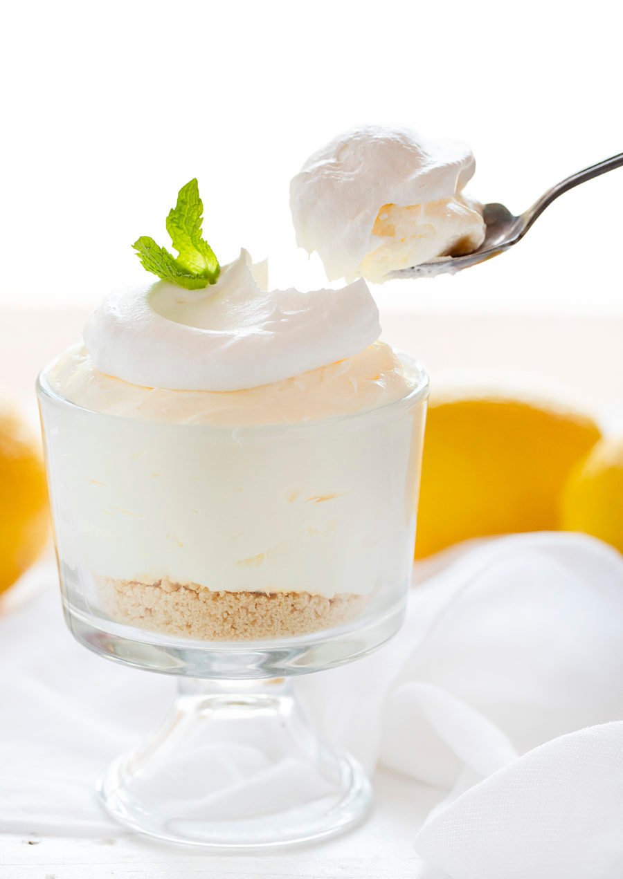 Lemon Mousse in a Parfait Glass with Spoon Removing a Bite.