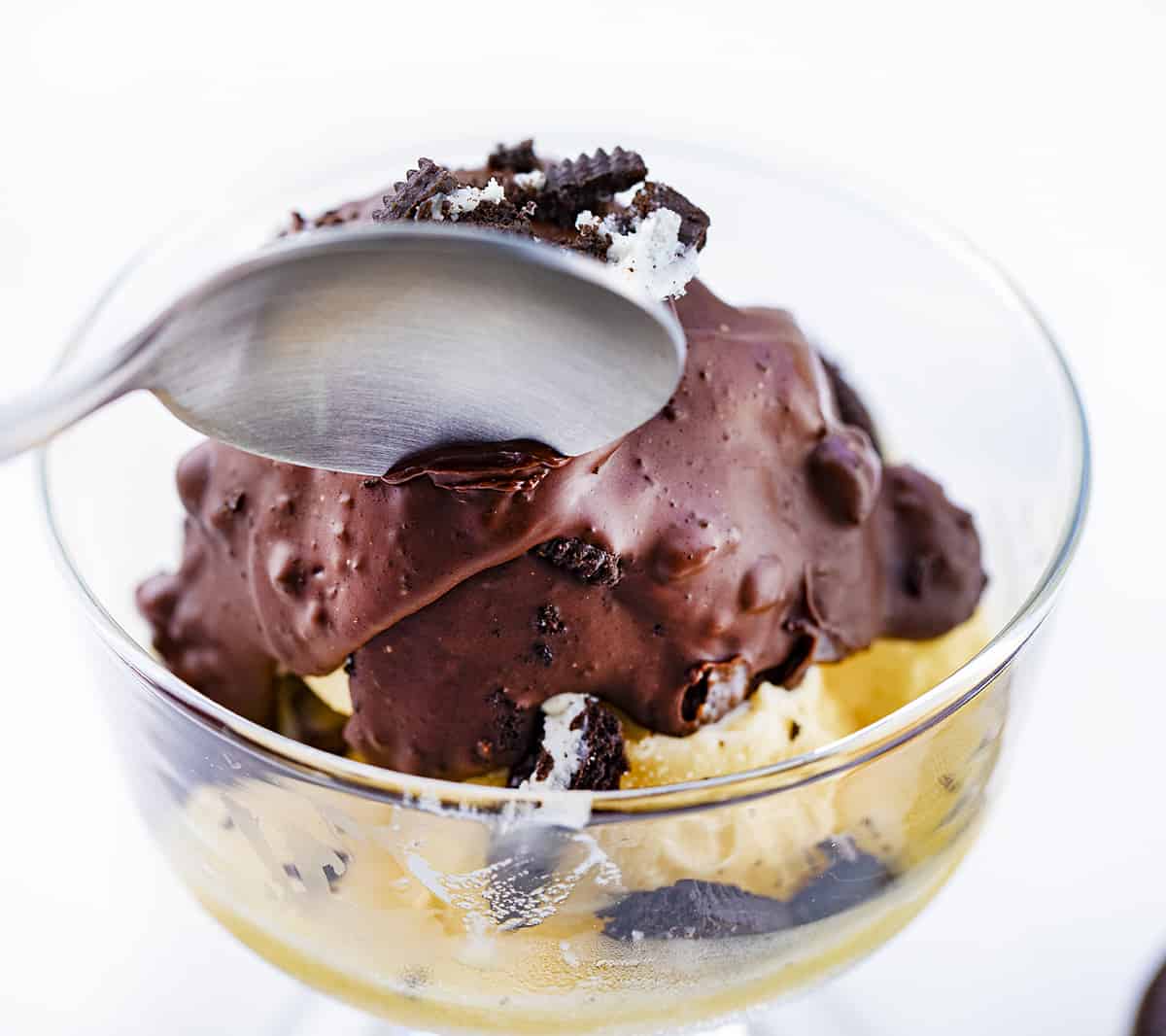 Spoon Breaking Through Oreo Chocolate Shell Topping on Ice Cream. ICe Cream Toppings, Dessert, Magic Shell, How to Make Magic Shell, Easy Chocolate Shell Recipes, No Bake Dessert, dessert recipes, Ice Cream Topping Ideas, i am baker, iambaker