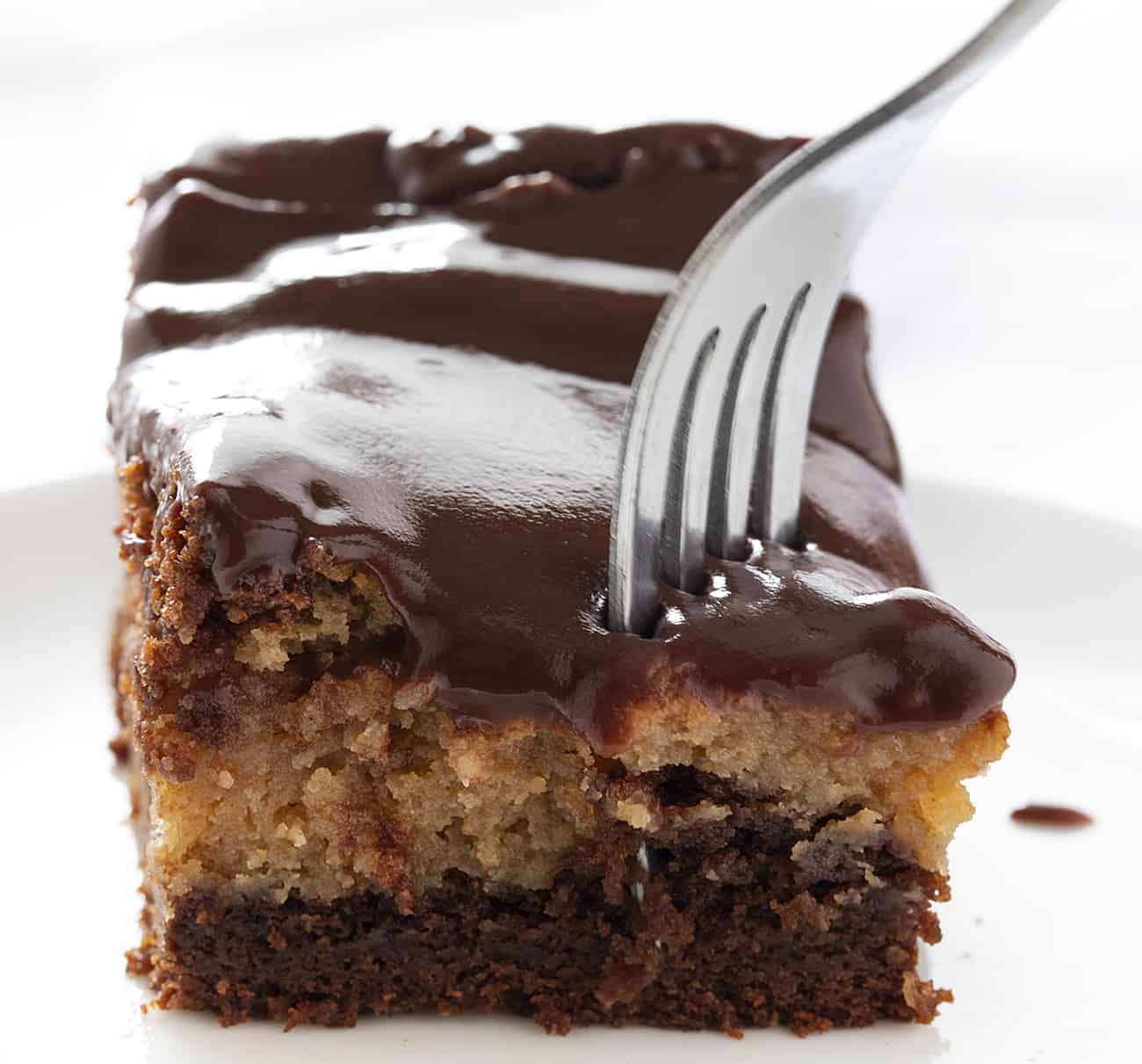 Fork Taking Piece from Chocolate Peanut Butter Ooey Gooey Cake 