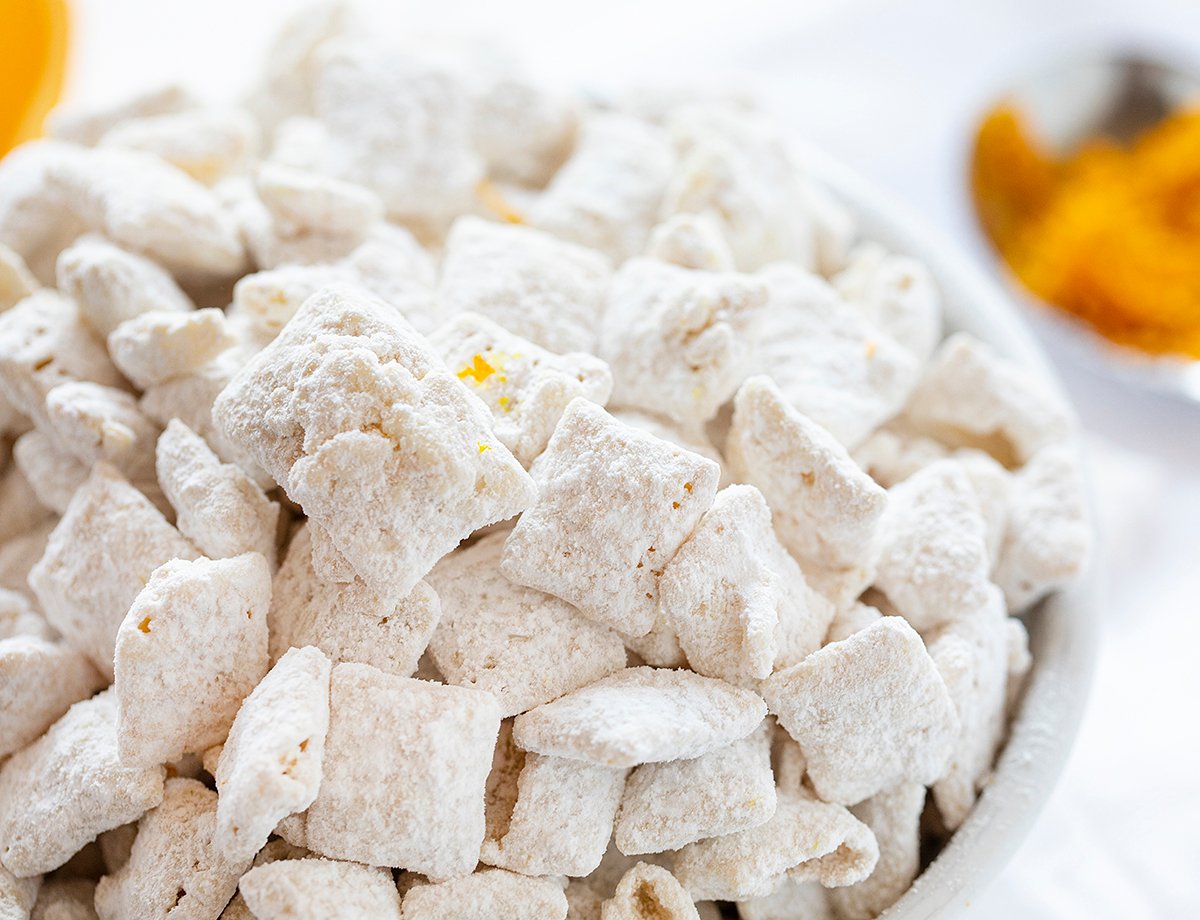 Orange Creamsicle Puppy Chow on White Bowl.