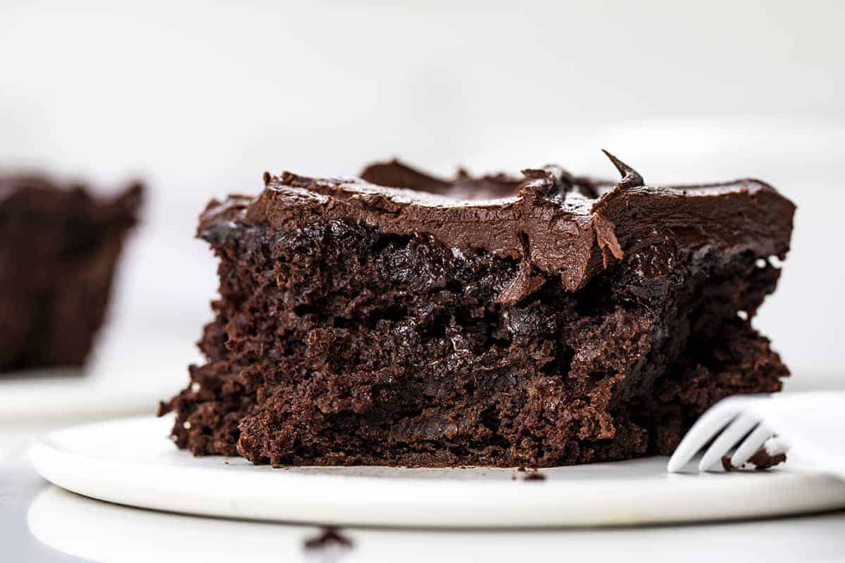 Piece of Chocolate Sauerkraut Cake with a Bite Removed and Fork Resting on the Plate.