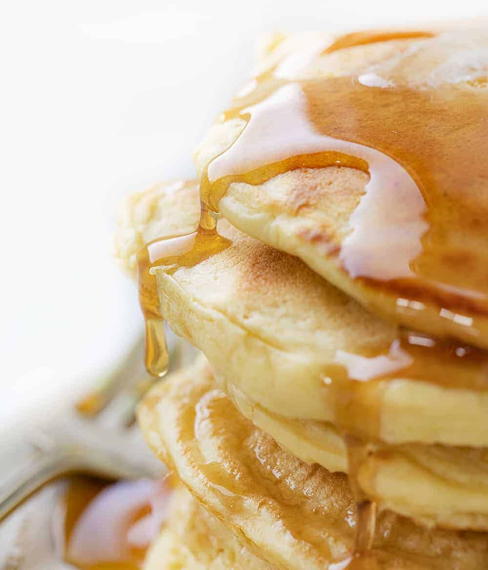 Close Up of Syrup Spilling over Stacked Sourdough Pancakes