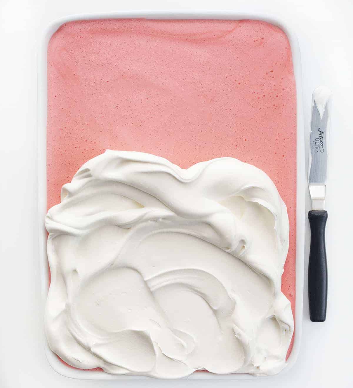 Adding Whipped Cream to Strawberry Icebox Cheesecake