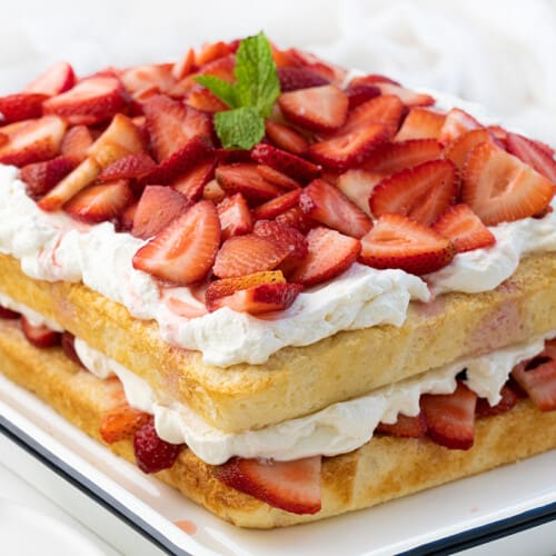 Sheet Pan Strawberry Shortcake in a Pan on a White Counter Turned at an Angle.