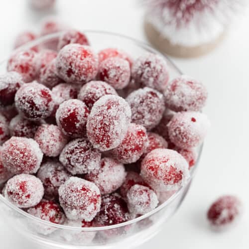 Close up of Sugared Cranberries in a Bowl on a White Counter.