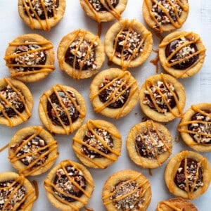 Several Turtle Cookie Cups on a White Counter from Overhead.