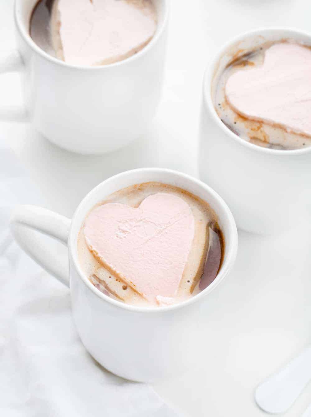 Three Mugs with Whipped Cream Heart for Hot Chocolate